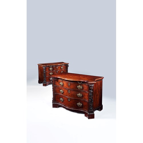 A highly important pair of serpentine fronted mahogany commodes